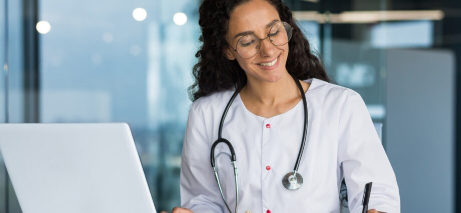 Online training. Young Latin American girl student doctor studies online at home from laptop